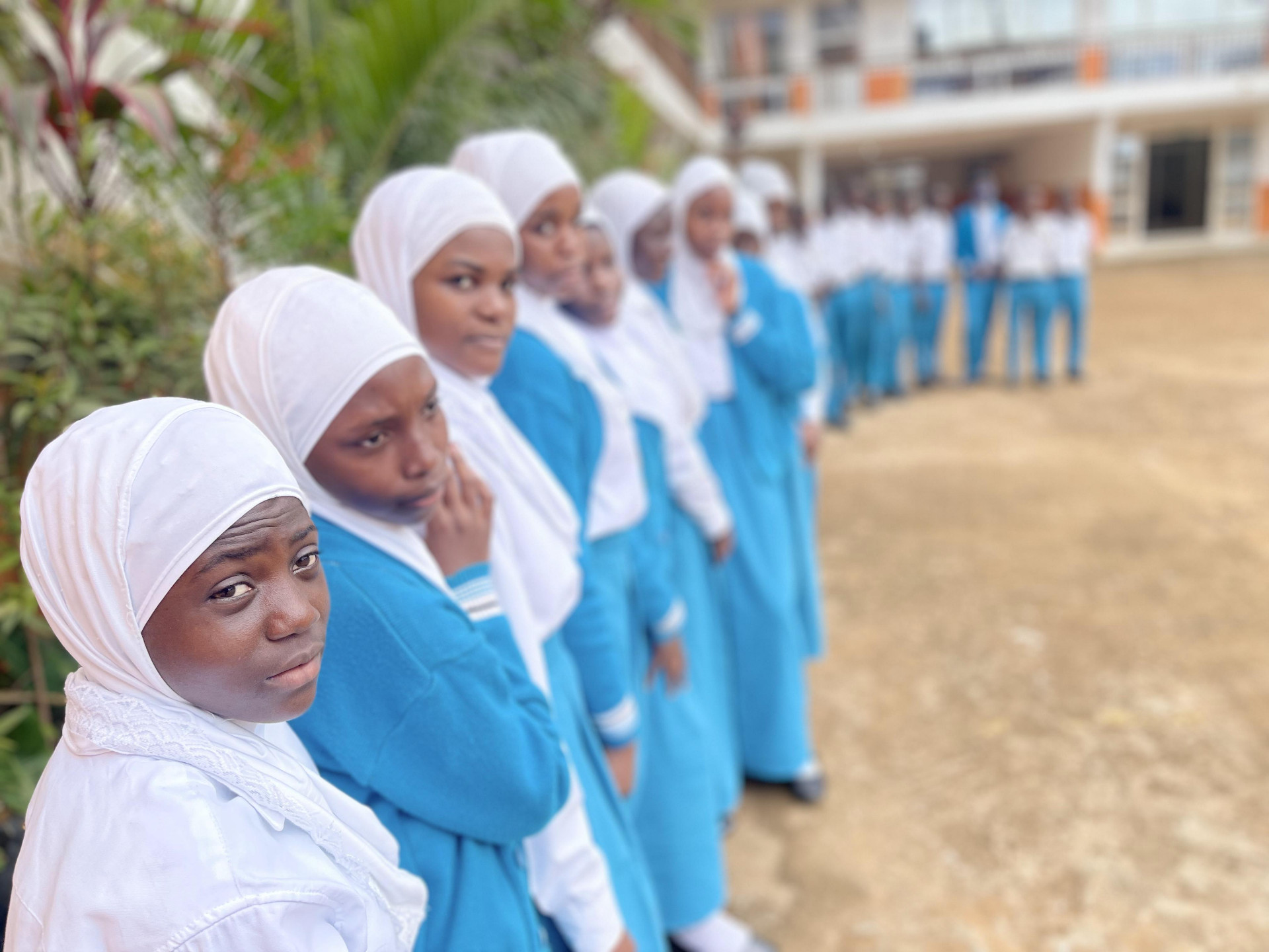 Female students lined up in blue uniforms