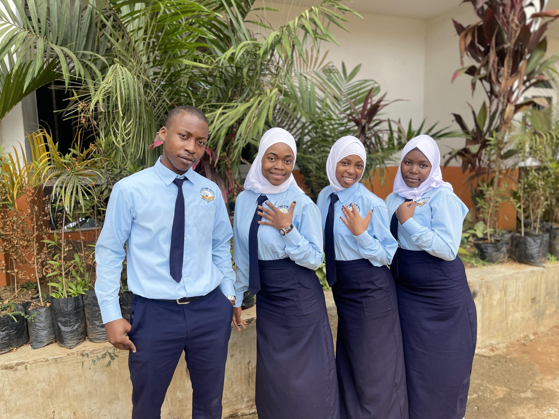 Students posing confidently in uniforms